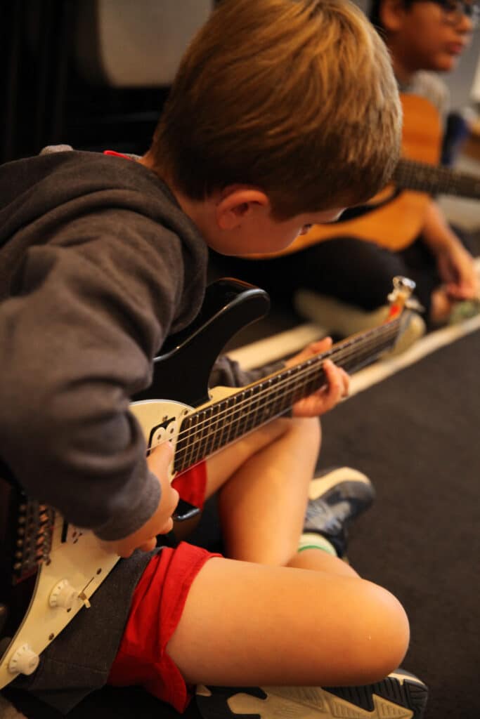 Student playing the guitar